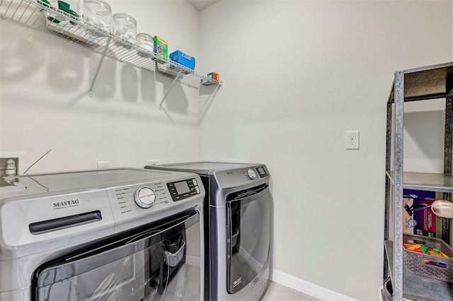 laundry room featuring washer and clothes dryer, laundry area, and baseboards