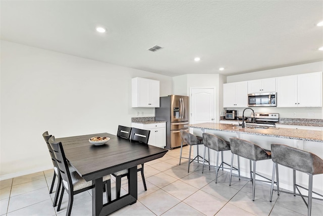 dining space featuring light tile patterned flooring, recessed lighting, and visible vents