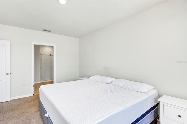 bedroom with visible vents, light colored carpet, and baseboards