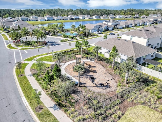 drone / aerial view with a residential view and a water view