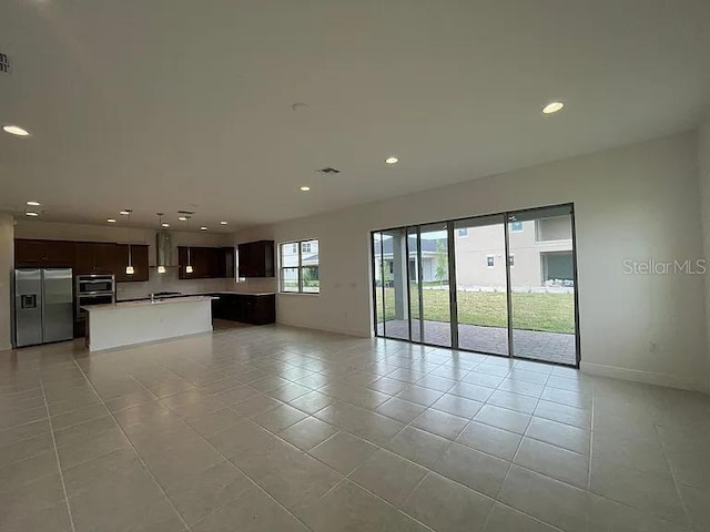 unfurnished living room with recessed lighting, visible vents, baseboards, and light tile patterned floors