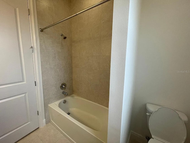 bathroom with shower / bathing tub combination, toilet, and tile patterned flooring