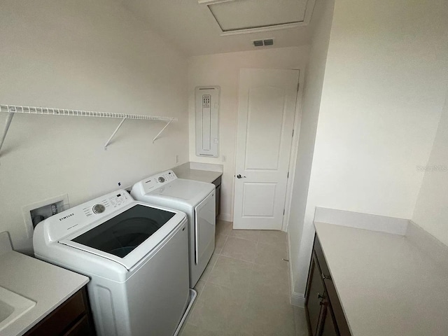 laundry room with visible vents, washer and dryer, cabinet space, light tile patterned flooring, and attic access