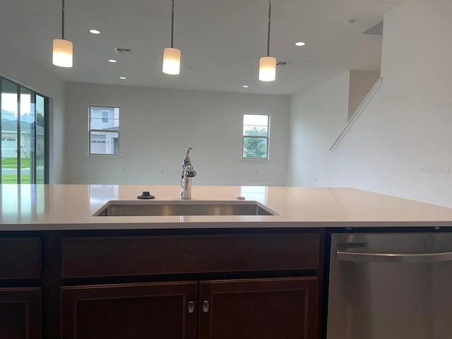 kitchen featuring visible vents, dishwasher, light countertops, and a sink