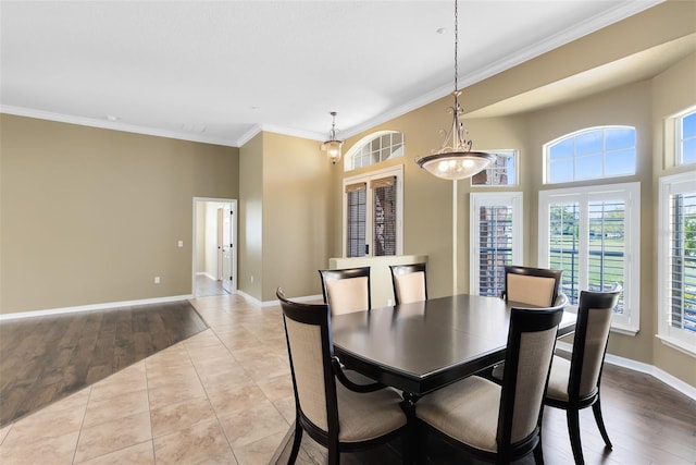 tiled dining space featuring visible vents, baseboards, and ornamental molding