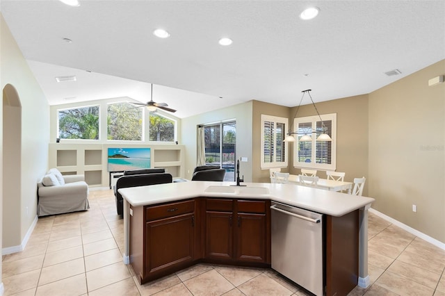 kitchen featuring visible vents, open floor plan, dishwasher, light countertops, and a sink