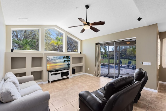 living room with vaulted ceiling, light tile patterned floors, visible vents, and ceiling fan