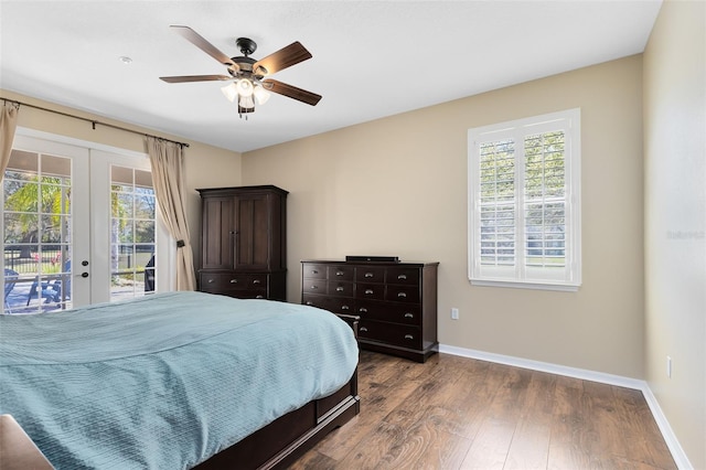 bedroom with access to exterior, multiple windows, french doors, and dark wood-style flooring