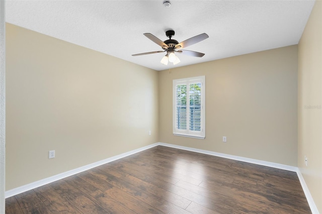 spare room with baseboards, a textured ceiling, ceiling fan, and dark wood-style flooring