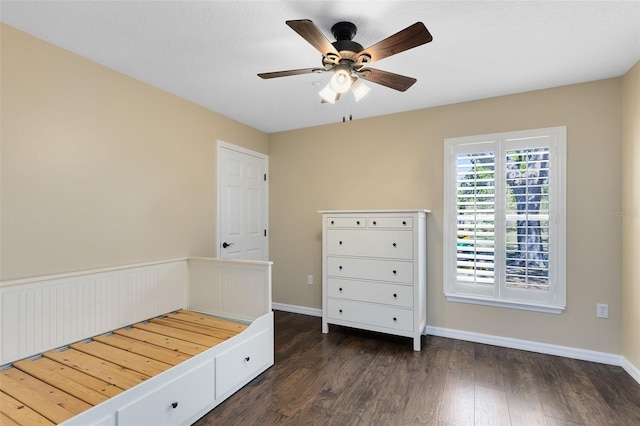 unfurnished bedroom featuring ceiling fan, baseboards, and wood finished floors