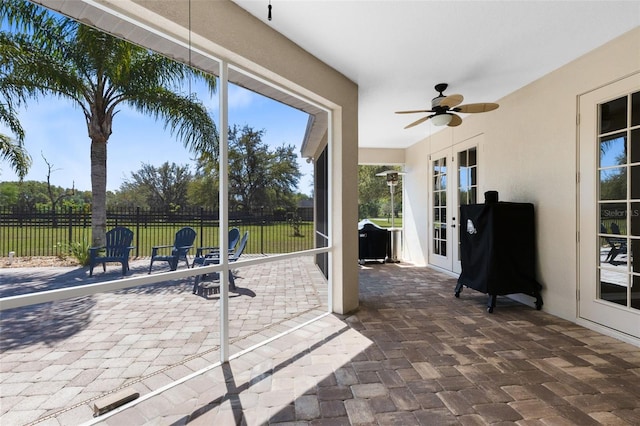 sunroom / solarium featuring ceiling fan