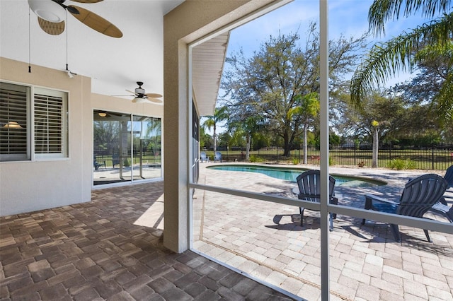 unfurnished sunroom featuring a ceiling fan