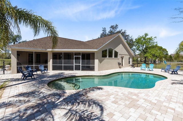 view of pool with a patio area, a fenced in pool, a sunroom, and fence