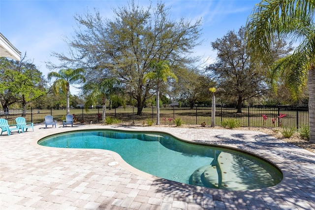 view of pool with a patio area, a fenced in pool, and fence