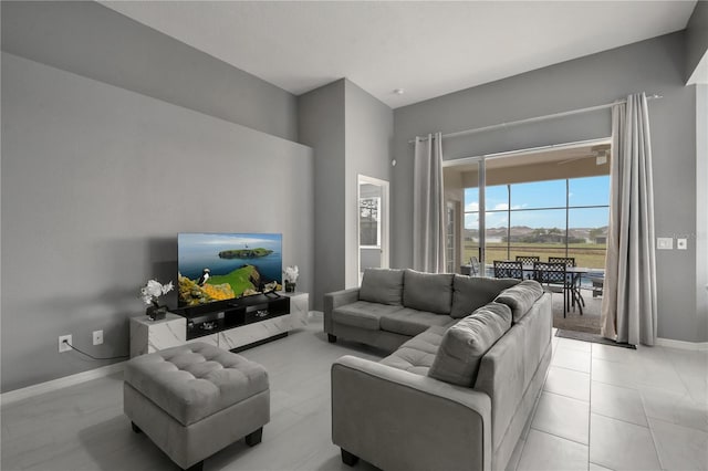 living area with light tile patterned floors and baseboards