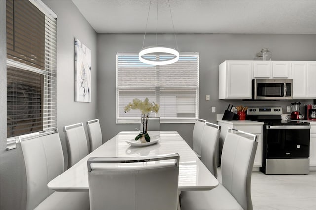 dining space with marble finish floor