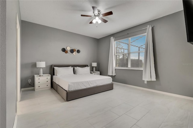 bedroom featuring a ceiling fan and baseboards