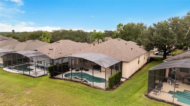 pool with a patio area, a lawn, and a lanai