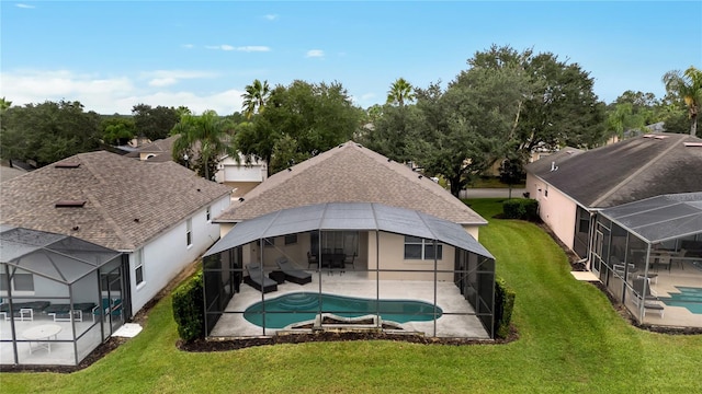 outdoor pool featuring a yard, a patio, and a lanai