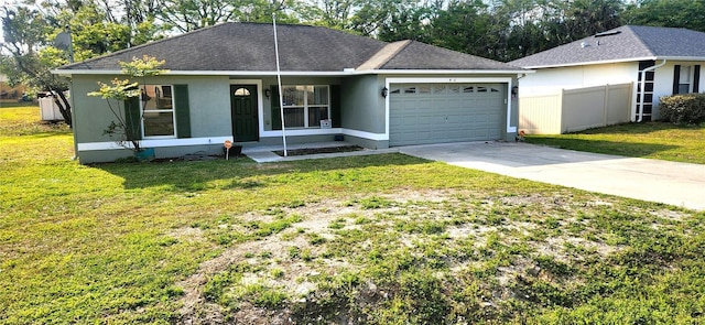 ranch-style house with fence, roof with shingles, a front yard, a garage, and driveway