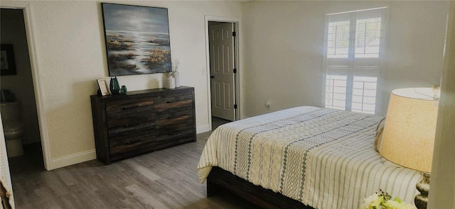 bedroom with baseboards and wood finished floors