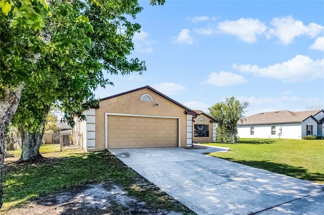 ranch-style home featuring a front yard, fence, stucco siding, concrete driveway, and a garage