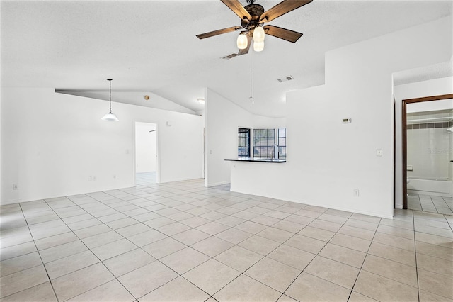 unfurnished living room featuring vaulted ceiling, light tile patterned flooring, visible vents, and ceiling fan