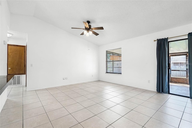 spare room featuring vaulted ceiling, a ceiling fan, and a wealth of natural light