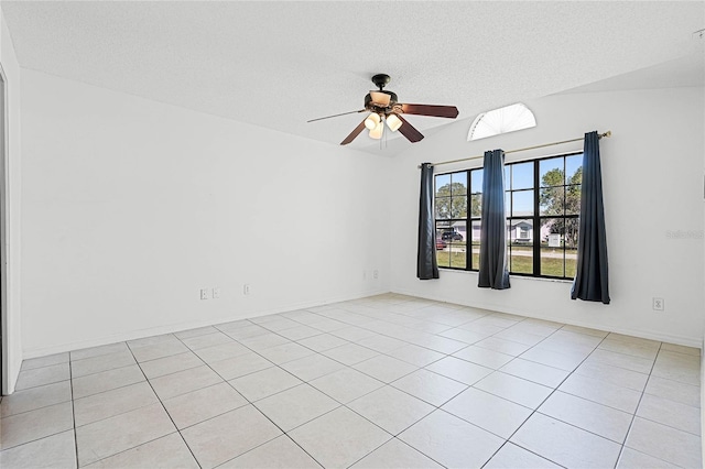 spare room with baseboards, a textured ceiling, and a ceiling fan