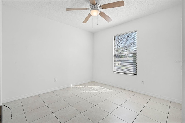 empty room with baseboards, a textured ceiling, and a ceiling fan