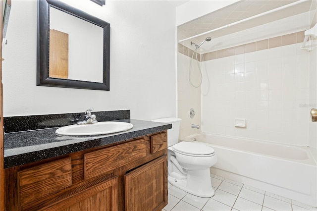 bathroom with tile patterned flooring, toilet, vanity, and bathing tub / shower combination