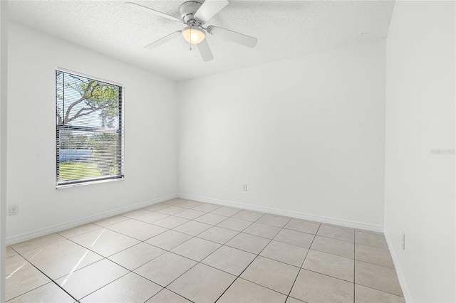 empty room featuring baseboards, a textured ceiling, and a ceiling fan