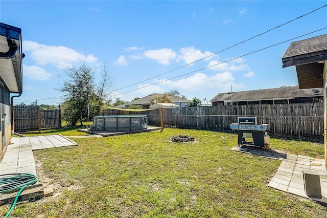 view of yard with a patio area, a fenced in pool, a fenced backyard, and an outdoor fire pit