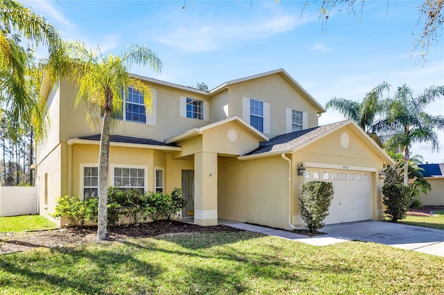 traditional-style home with stucco siding, a garage, concrete driveway, and a front lawn