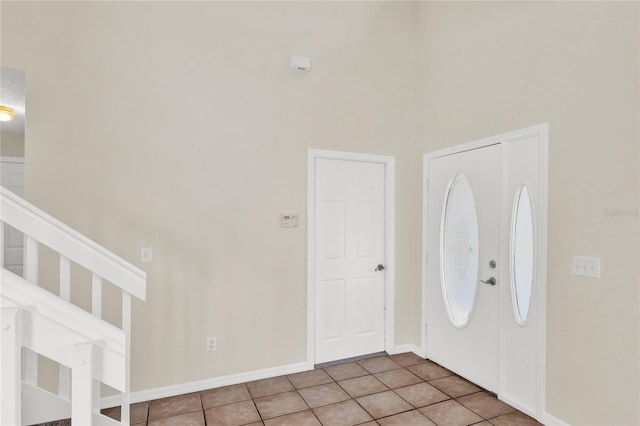 foyer entrance featuring tile patterned flooring and baseboards