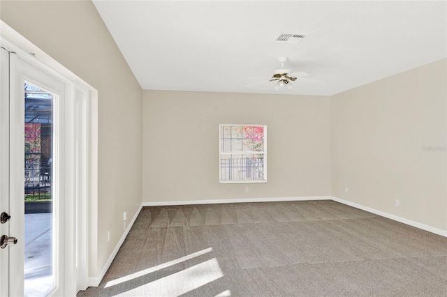 unfurnished room with visible vents, baseboards, a ceiling fan, and carpet floors