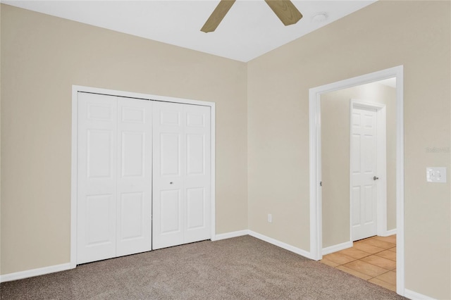 unfurnished bedroom with a ceiling fan, baseboards, a closet, and carpet floors