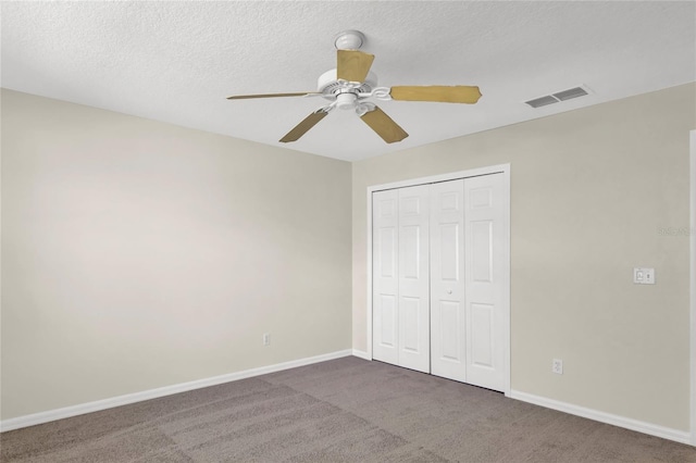 unfurnished bedroom with a closet, visible vents, baseboards, and carpet floors