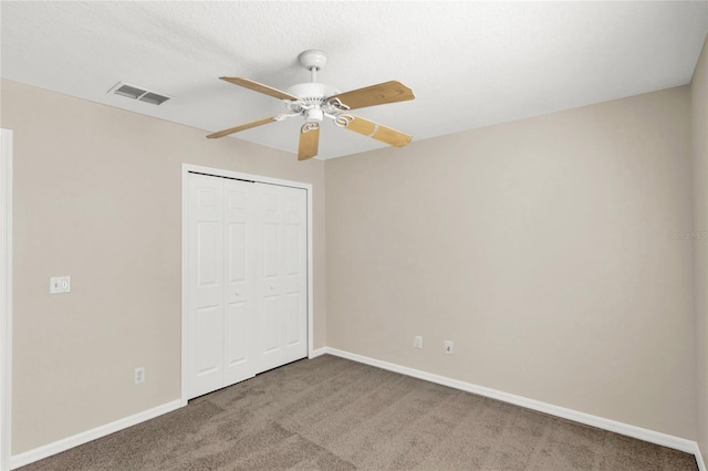 unfurnished bedroom with a closet, baseboards, visible vents, and carpet floors