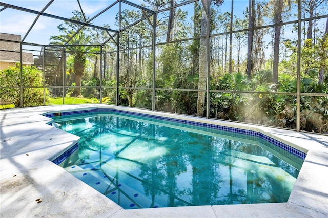 pool with glass enclosure and a patio area