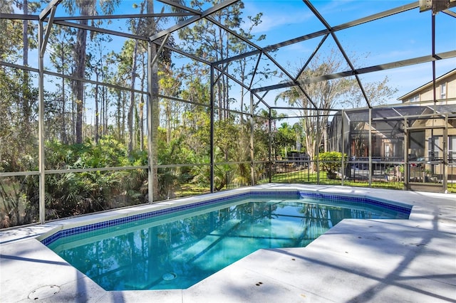 outdoor pool featuring a lanai and a patio area