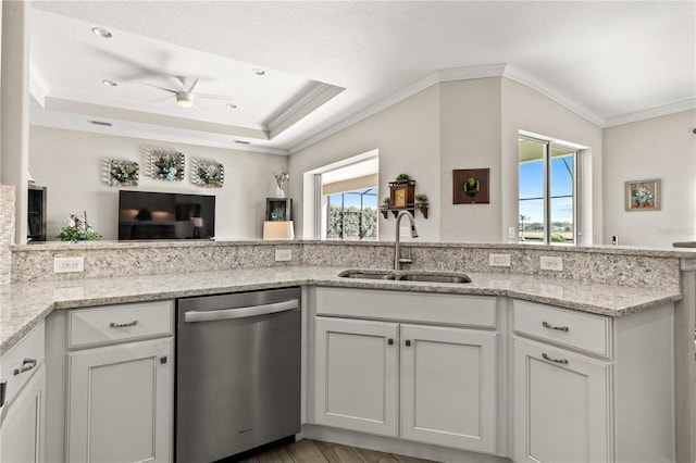 kitchen featuring light stone countertops, ornamental molding, stainless steel dishwasher, white cabinets, and a sink