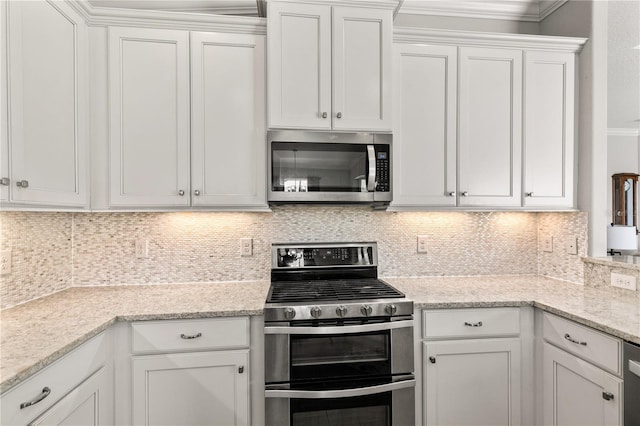 kitchen with white cabinetry, backsplash, and stainless steel appliances