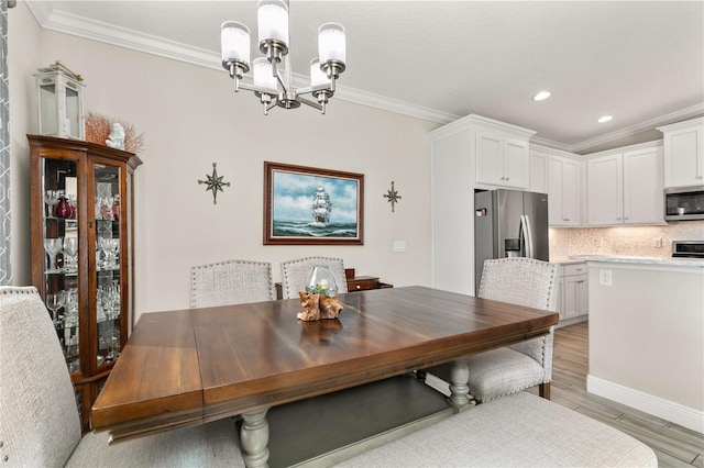 dining area featuring a notable chandelier, light wood-style floors, recessed lighting, and ornamental molding