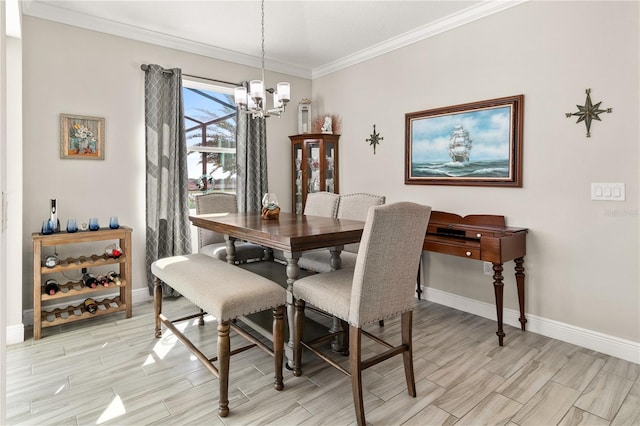 dining area featuring crown molding, a notable chandelier, baseboards, and wood finish floors