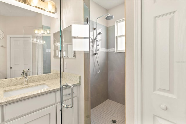 full bathroom with a stall shower and vanity