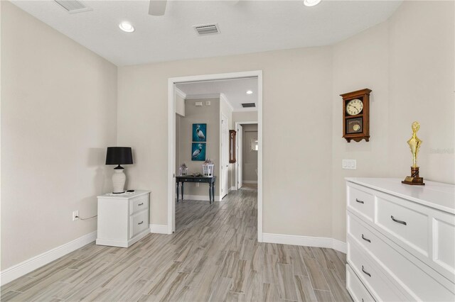 interior space featuring light wood-type flooring, visible vents, baseboards, and recessed lighting