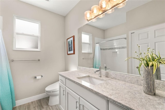 bathroom with vanity, a shower with curtain, wood finished floors, baseboards, and toilet