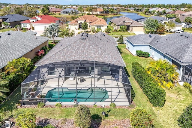 outdoor pool with a residential view, a lanai, a water view, and a patio area