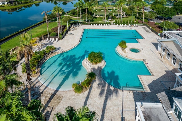 view of pool with a water view and a patio area